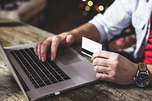 man using credit card to purchase b2b lead generation services online